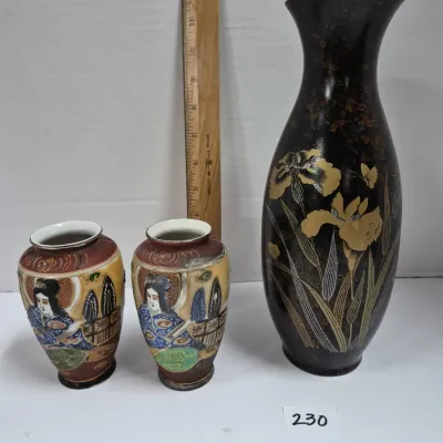 Sale Photo Thumbnail #394: Trio of decorative Asian vases, including a matching pair of hand-painted porcelain Kutani-style vases featuring figures and a larger dark lacquered metal vase with floral iris accents.
