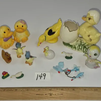 Sale Photo Thumbnail #254: Collection of vintage duck and chick figurines, including ceramic, porcelain, and glass pieces in various sizes.