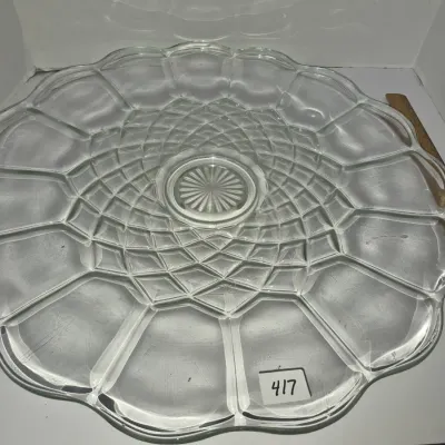Sale Photo Thumbnail #732: Large clear glass serving platter featuring a scalloped rim and a geometric, diamond-cut pattern radiating from the center.