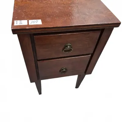 Sale Photo Thumbnail #173: Vintage dark stain wooden two-drawer nightstand or accent table with ring pull hardware, showing surface wear and scuffs on top.