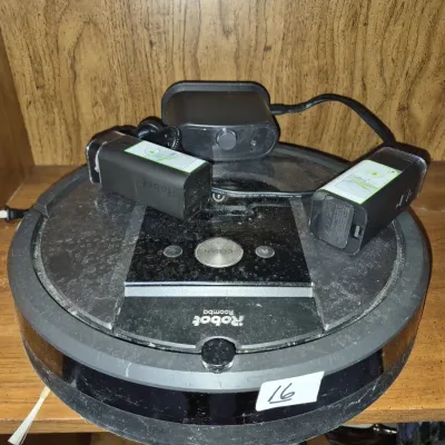 Sale Photo Thumbnail #26: iRobot Roomba robotic vacuum cleaner with charging dock, power cord, and virtual wall barriers.