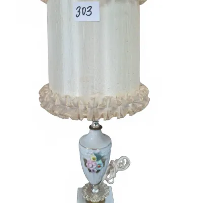 Sale Photo Thumbnail #537: Vintage porcelain urn-style table lamp with floral accents, marble base, and ruffled cream fabric shade.