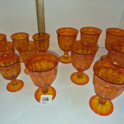 Sale Photo Thumbnail #421: Set of 12 vintage amberina glass footed goblets featuring a paneled thumbprint design.