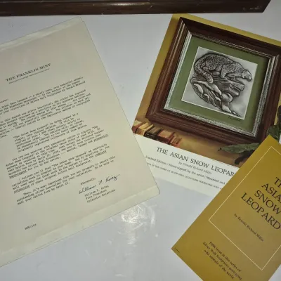 Sale Photo Thumbnail #593: Vintage Franklin Mint paperwork and promotional booklet for "The Asian Snow Leopard" silver wall sculpture by Donald Richard Miller.