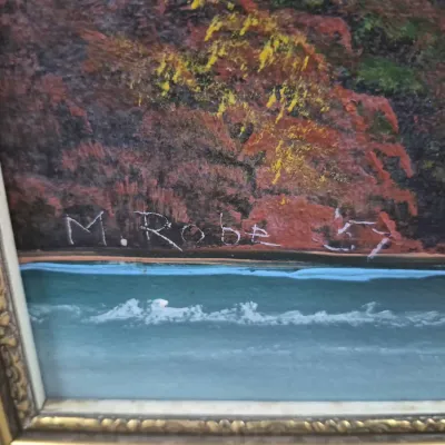 Sale Photo Thumbnail #497: Close-up detail of a framed landscape painting signature reading "M. Robe '57" along the shoreline scene.