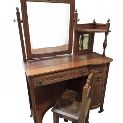 Sale Photo Thumbnail #167: Antique carved wood vanity dresser with attached swivel mirror, tiered shelf, and matching wooden chair, circa late 19th or early 20th century.
