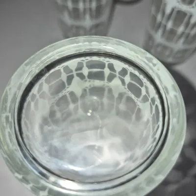 Sale Photo Thumbnail #612: Top-down view of mid-century modern highball glasses featuring a white geometric lattice pattern.