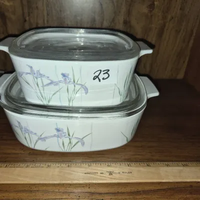 Sale Photo Thumbnail #37: Stack of two CorningWare casserole dishes in the Shadow Iris pattern, complete with clear glass lids.