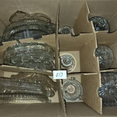 Sale Photo Thumbnail #548: Cardboard box lot filled with various clear pressed glass dishes, lids, and small tableware items.