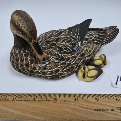 Sale Photo Thumbnail #249: Detailed hand-painted duck figurine featuring a preening mother mallard duck nestled with two small ducklings.