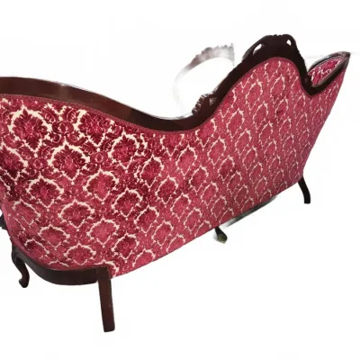 Sale Photo Thumbnail #107: Victorian-style camelback sofa with carved dark wood frame and red damask velvet upholstery, rear view.