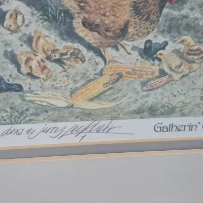 Sale Photo Thumbnail #485: Framed artwork titled "Gatherin' Eggs" featuring a hen and chicks, signed by artists Don and Jerry Locklair in pencil along the bottom margin.