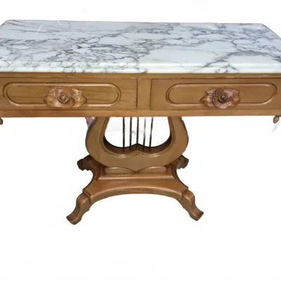 Sale Photo Thumbnail #119: Vintage lyre-base console table featuring a white-and-gray marble top, two drawers with carved floral handles, and a pedestaled harp-style support.