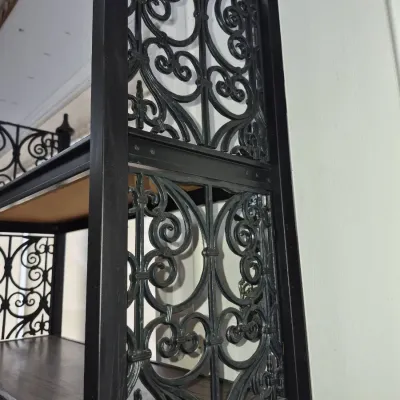 Sale Photo Thumbnail #730: Black wrought iron shelving unit with ornate scrolled side panels and dark wood shelves.
