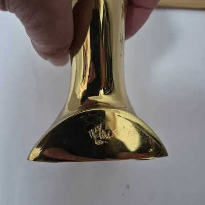 Sale Photo Thumbnail #770: Polished brass piece stamped with a 'W&M' maker's mark.