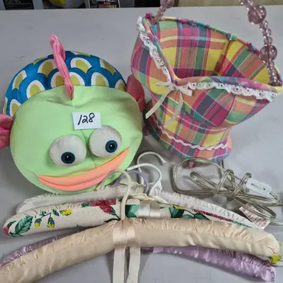Sale Photo Thumbnail #209: Whimsical colorful home decor lot featuring a plush fish head piece, a plaid fabric basket, satin padded clothes hangers, and an electrical cord.