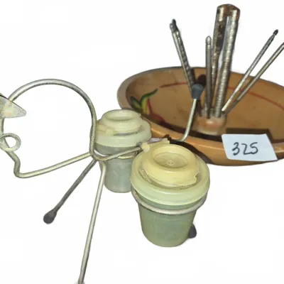 Sale Photo Thumbnail #567: Vintage wire salt and pepper shaker holder shaped like a bird with plastic shakers, alongside a mid-century wooden nut bowl set with nutcrackers and picks.