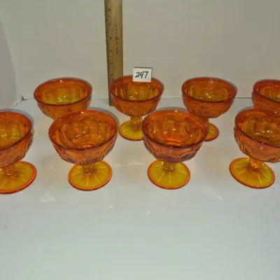 Sale Photo Thumbnail #422: Set of eight vintage amberina glass footed dessert or sherbet cups with paneled bowls and starburst bases.