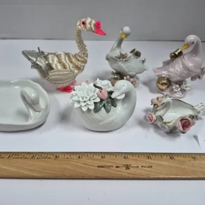 Sale Photo Thumbnail #446: Collection of six vintage swan-themed decorative items, including ceramic figurines, trinket dishes, and a woven fiber swan.