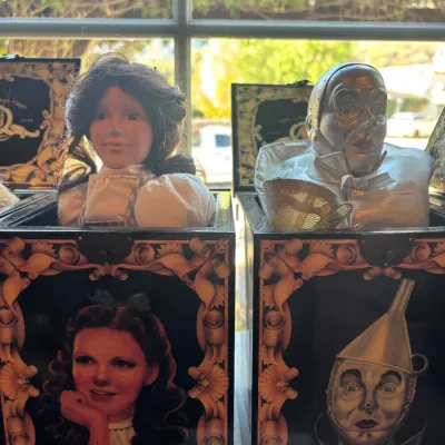 Pair of collectible Wizard of Oz musical jack-in-the-boxes featuring Dorothy Gale and the Tin Man with detailed character busts and...
