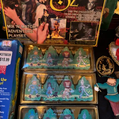 Sale Photo Thumbnail #108: Collection of Wizard of Oz collectibles, including a Mix 'N' Match Adventure Playset box and three packages of 9-foot paper garlands featuring character cutouts.