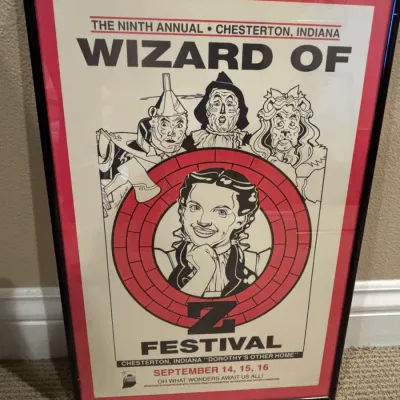 Framed Ninth Annual Chesterton, Indiana Wizard of Oz Festival poster, featuring illustrated characters in black and white with red accents.