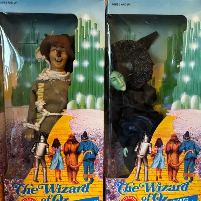 Sale Photo Thumbnail #104: Two vintage 1988 Turner Entertainment The Wizard of Oz 50th Anniversary collectible dolls in original packaging, featuring the Scarecrow and the Wicked Witch.