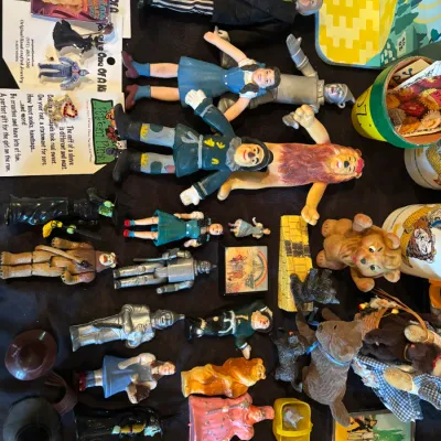 Sale Photo Thumbnail #129: Collection of vintage Wizard of Oz memorabilia, featuring action figures, figurines, pins, and small collectibles across various eras.