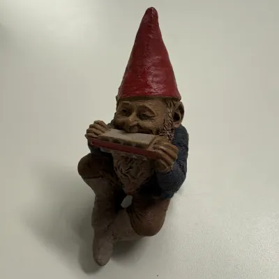 Vintage Tom Clark resin gnome figurine playing a harmonica, featuring hand-painted details.