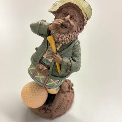 Tom Clark gnome figurine named 'Andrew,' featuring a Scottish golfer in a kilt standing beside a golf ball, dated 1980s.