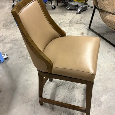 Contemporary counter-height dining chair featuring a wooden frame with beige leather upholstery and lower support stretchers.