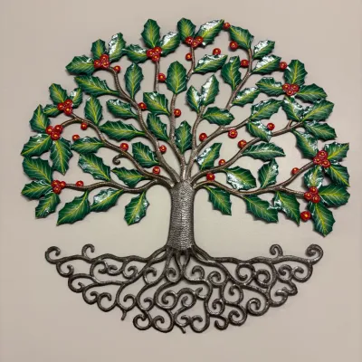 Hand-painted metal tree of life wall art featuring green holly leaves, red berries, and intricate scrollwork roots.