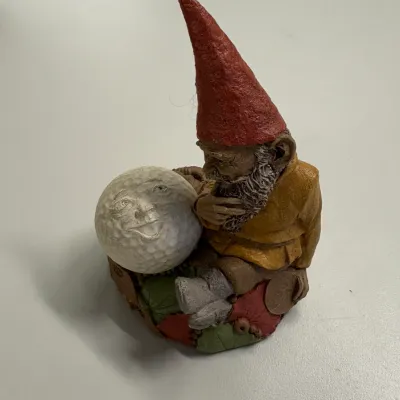Tom Clark resin gnome figurine titled "Fore", featuring a garden gnome sitting beside a golf ball with a face.