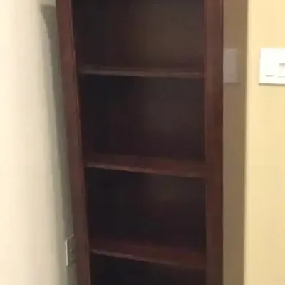 Contemporary dark mahogany-finished wooden bookcase featuring four open storage shelves.