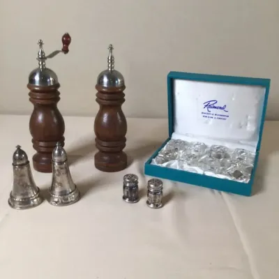 Vintage table serving collection, including wooden pepper mill and salt shaker pair, silver-plated shakers, miniature glass shakers, and...