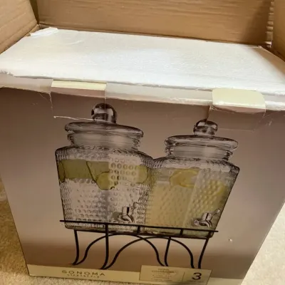 Sonoma Lifestyle 3-piece beverage dispenser set in original retail packaging, featuring dual glass jars on a black metal stand.