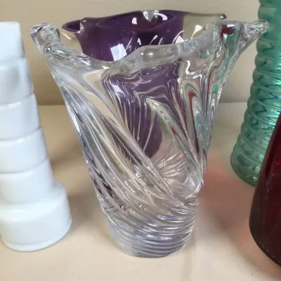 Selection of vintage art glass vases, including a clear swirling studio glass vase and a deep purple cased glass vase.
