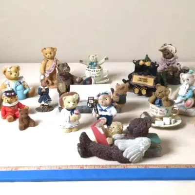 Collection of vintage teddy bear resin figurines and miniatures, displayed with a ruler for scale.