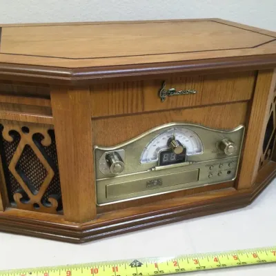 Vintage-style Emerson wood-cased tabletop music center featuring an AM/FM tuner, CD player, and integrated speakers.