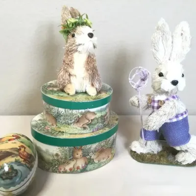 Collection of Easter decor items, including two sisal bunny figurines, a set of stacked decorative nesting boxes, and a decoupage egg...