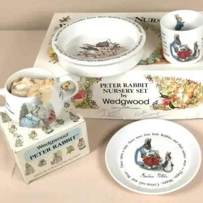 Vintage Wedgwood Peter Rabbit nursery tableware set, featuring Beatrix Potter illustrations on porcelain bowls, mugs, and a small plate...