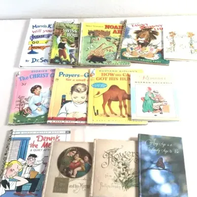 Collection of vintage children's books and hardcovers, including Little Golden Books, Dr. Seuss, and Rand McNally titles.