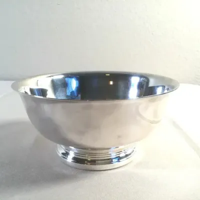 Polished silver-plated revere bowl with a molded pedestal base.