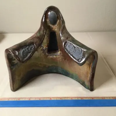 Abstract studio pottery Raku fire sculpture with earthy glaze finishes and stylized embossed patterns, measuring approximately 9 inches...