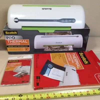 Scotch Pro thermal laminator with original box and two packages of laminating pouches.