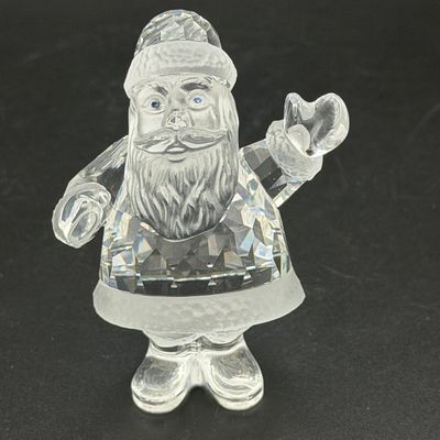 Sale Photo Thumbnail #26: Swarovski crystal Santa Claus figurine featuring a faceted body, frosted face and trim details, and blue crystal eyes.