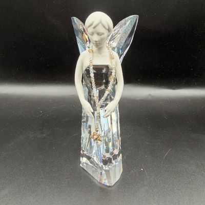 Sale Photo Thumbnail #37: Swarovski crystal angel figurine featuring a frosted glass head and arms with faceted clear glass wings and gown, draped with a crystal bead necklace.