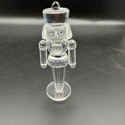 Sale Photo Thumbnail #13: Swarovski crystal nutcracker figurine featuring faceted clear glass with frosted accents and blue crystal eyes.