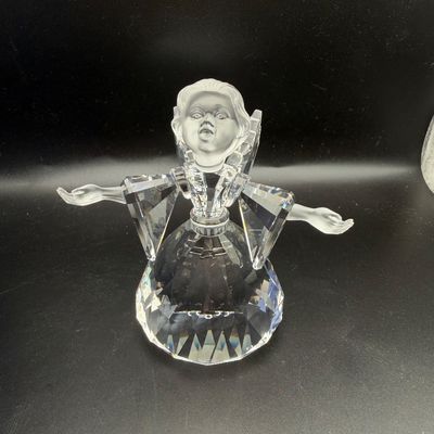 Sale Photo Thumbnail #34: Swarovski crystal angel figurine with frosted face and hands, featuring open arms and faceted crystal robe.
