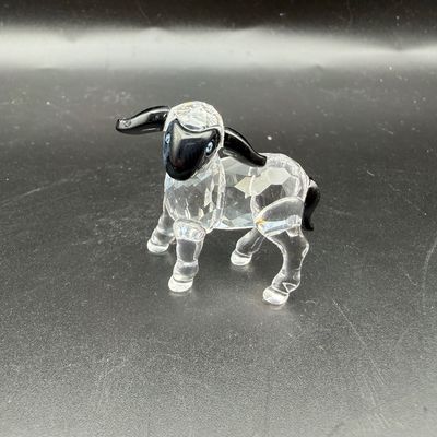 Sale Photo Thumbnail #33: Swarovski crystal black-faced sheep figurine featuring a clear faceted body and black crystal head, ears, and tail.